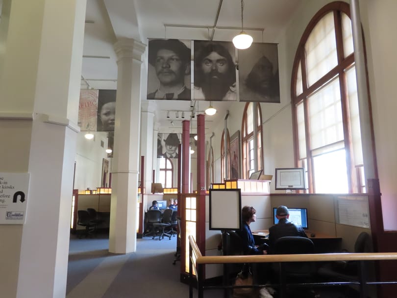 Visitors searching immigration records inside the Ellis Island museum