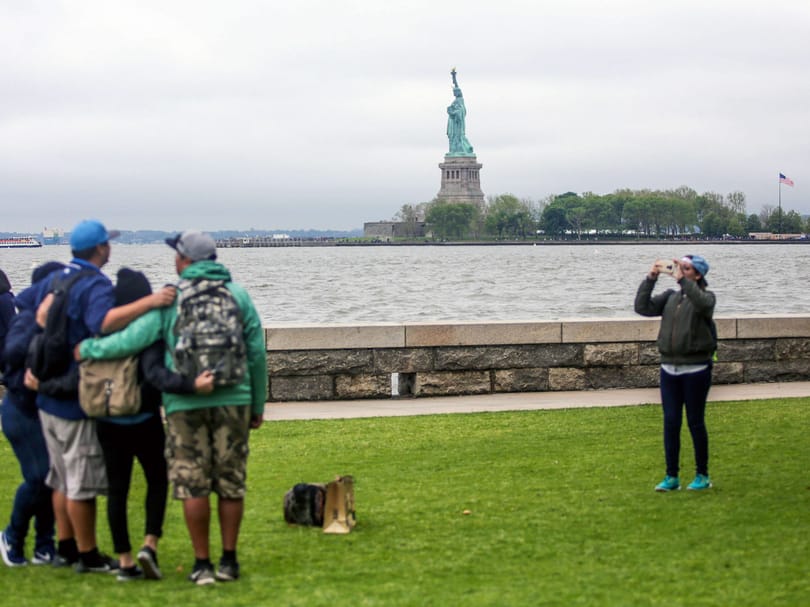 photo with statue of liberty in background