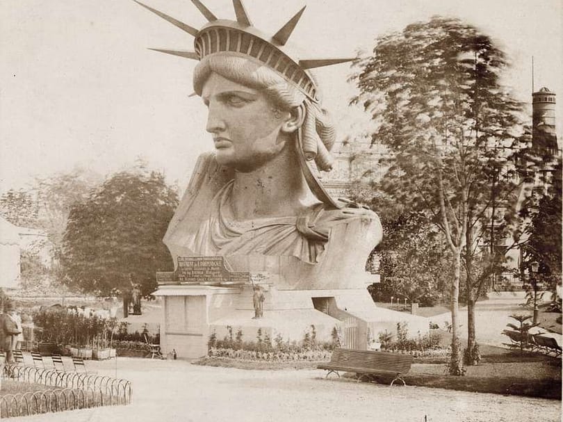Historic photograph of the Statue of Liberty’s head displayed in a Paris park before the completed monument was assembled in New York.