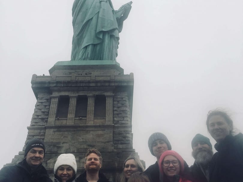 Group photo in front of the statue of liberty