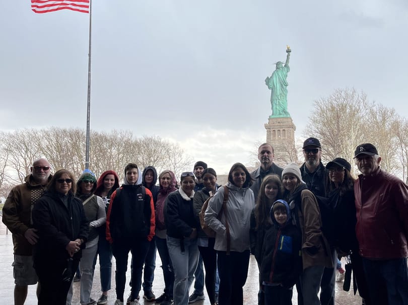 group photo in front of statue of liberty