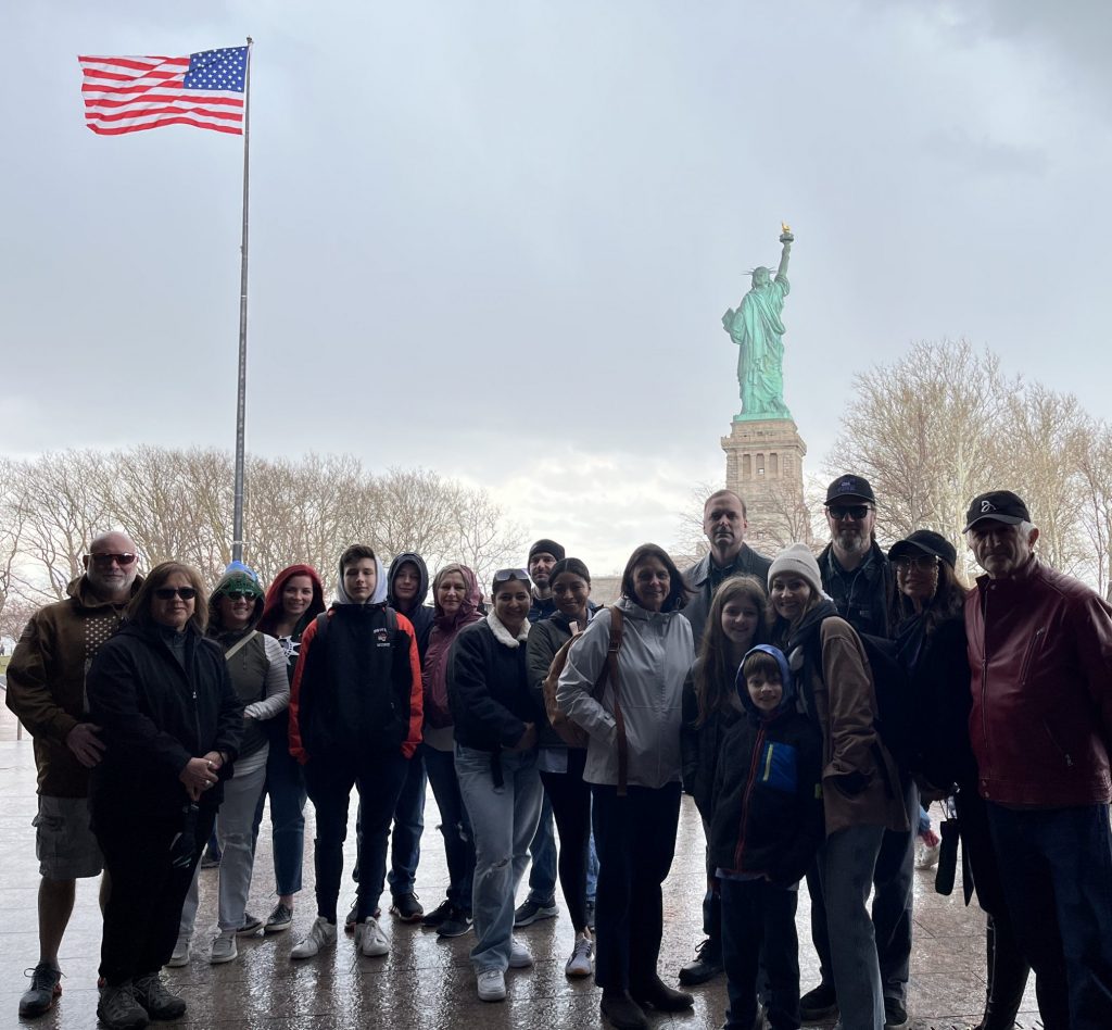 group photo in front of statue of liberty