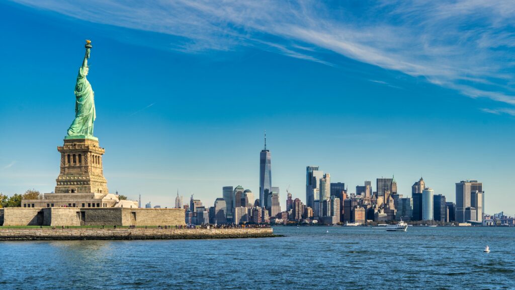 Statue of Liberty and Manhattan skyline across body of water