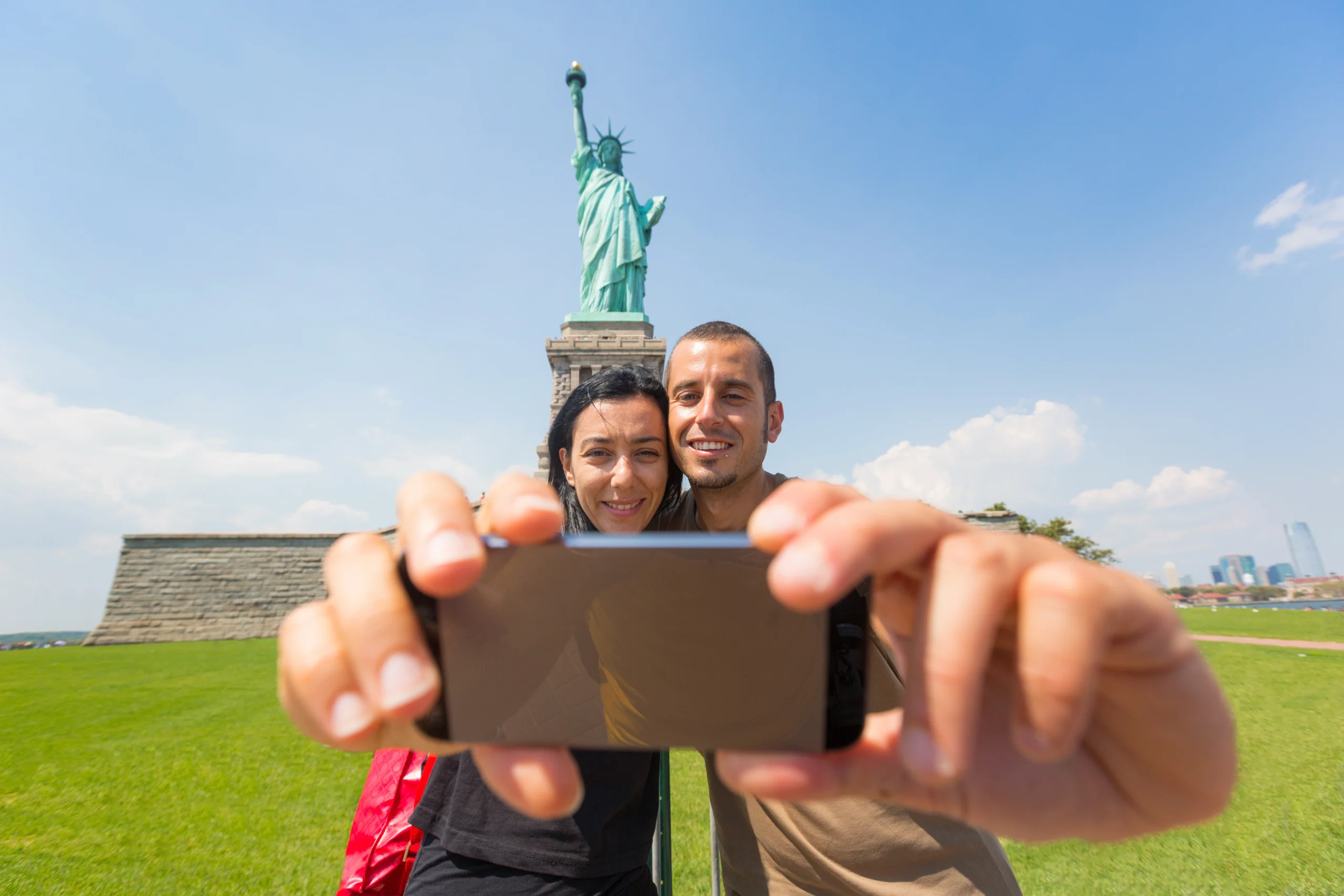 Couple taking a photo with Lady of Liberty statue during Lower Manhattan tour