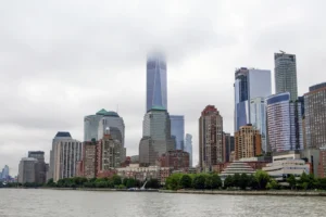 Manhattan skyline covered by clouds, seen from Liberty Island