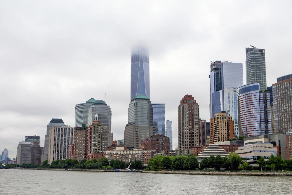 Manhattan skyline covered by clouds, seen from Liberty Island