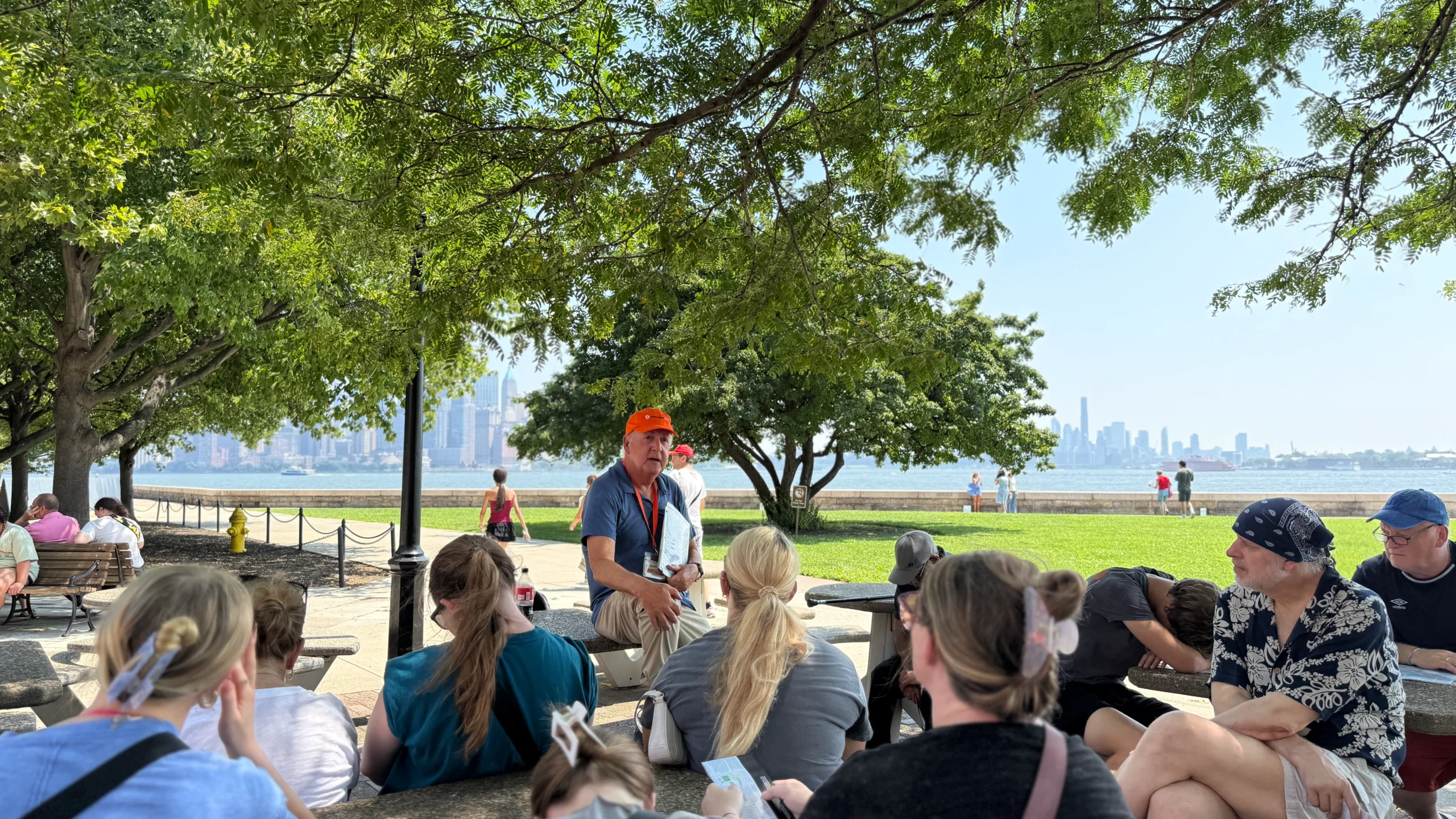 Tour guide and group sitting down during Statue of Liberty and Ellis Island tour